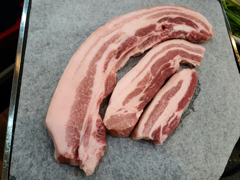 Strips of raw pork belly